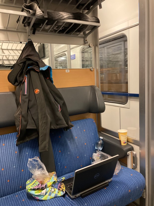 A photo of Jiri's work laptop on a train seat
